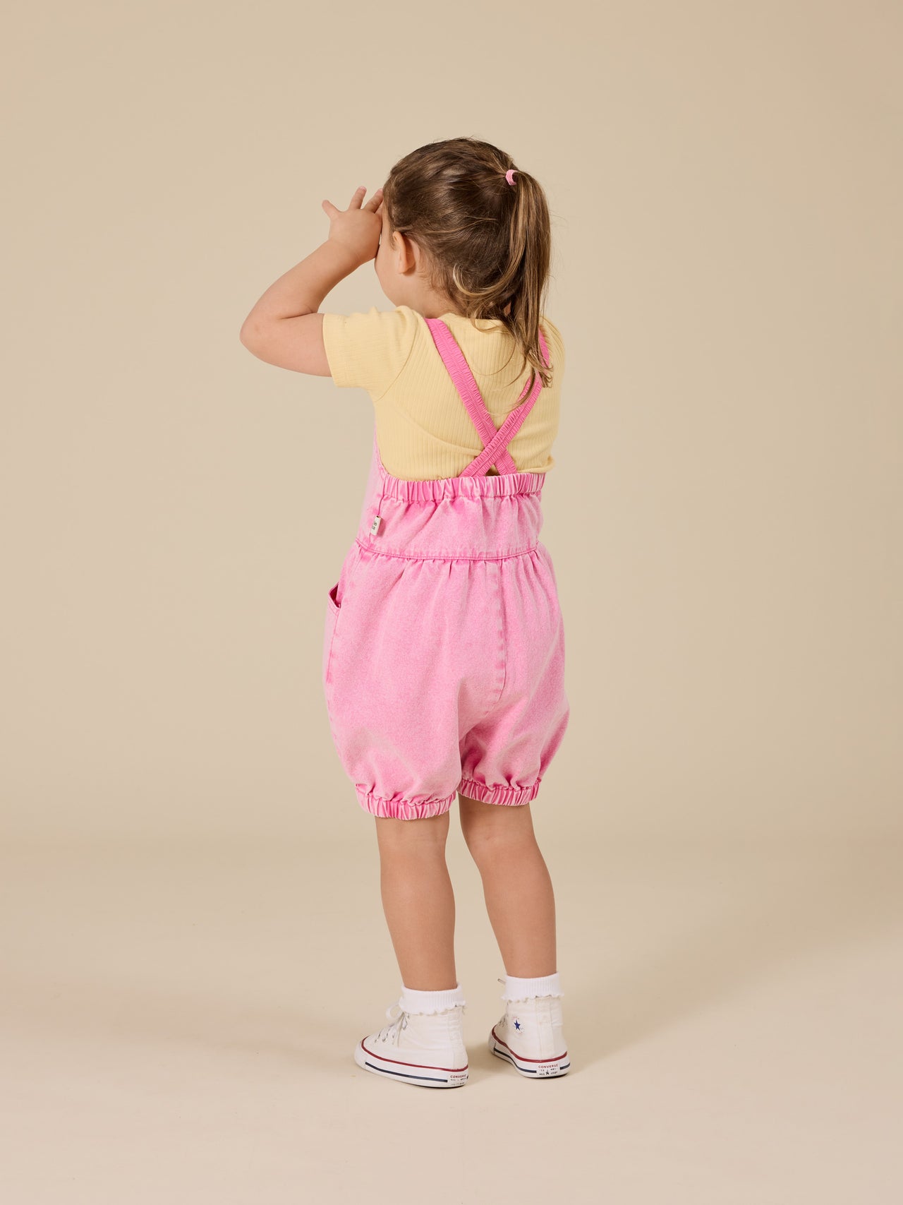 The Goldie + Ace Cindy Denim Bubble Overalls in Pink Lemonade pictured on a transparent background. The material is cotton. It is a overall made for babies, toddlers and kids.