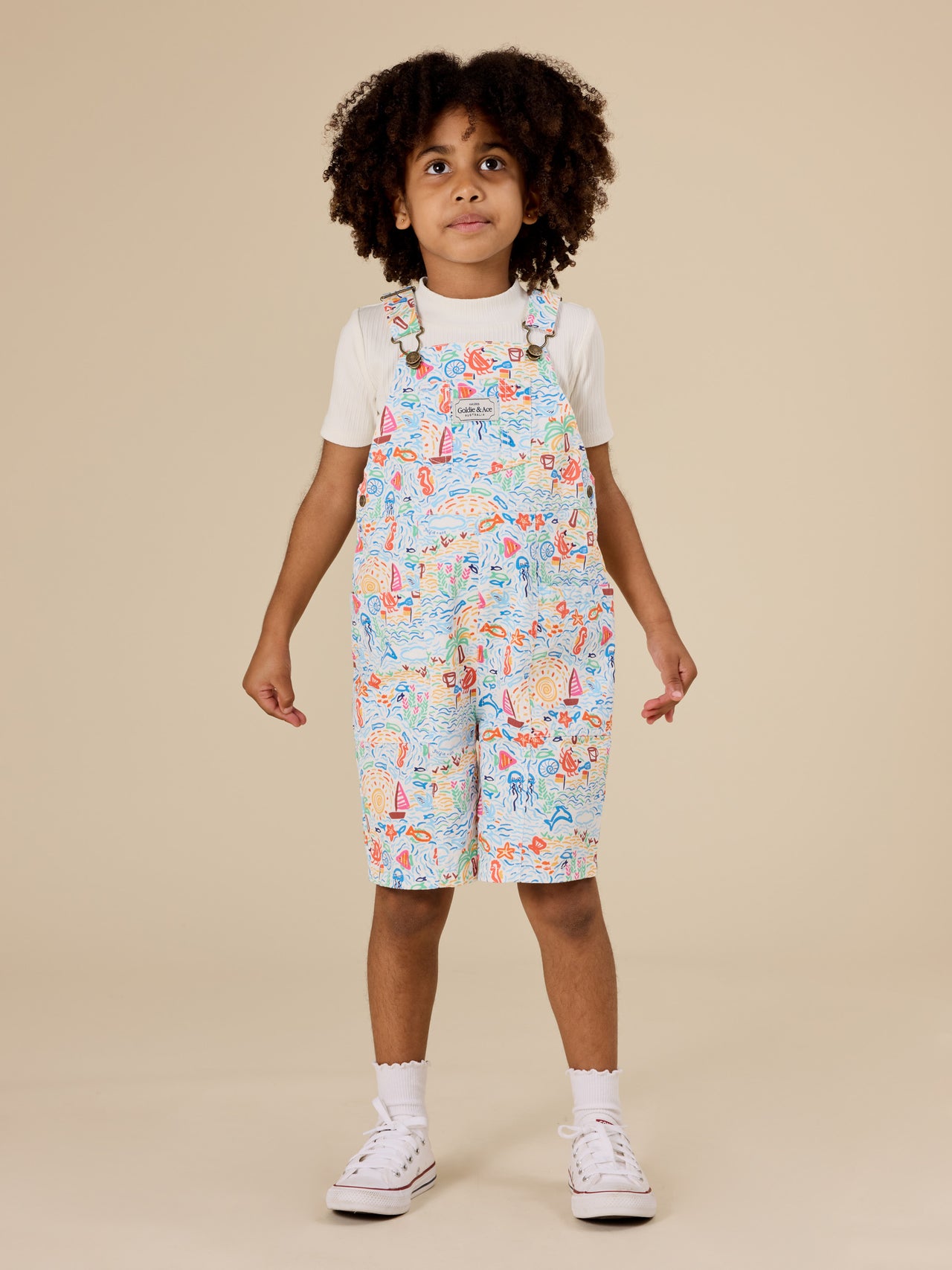 The Goldie + Ace Summer Bay James Pocket Overalls in Multi pictured on a transparent background. The material is twill. It is a overall made for babies, toddlers and kids.