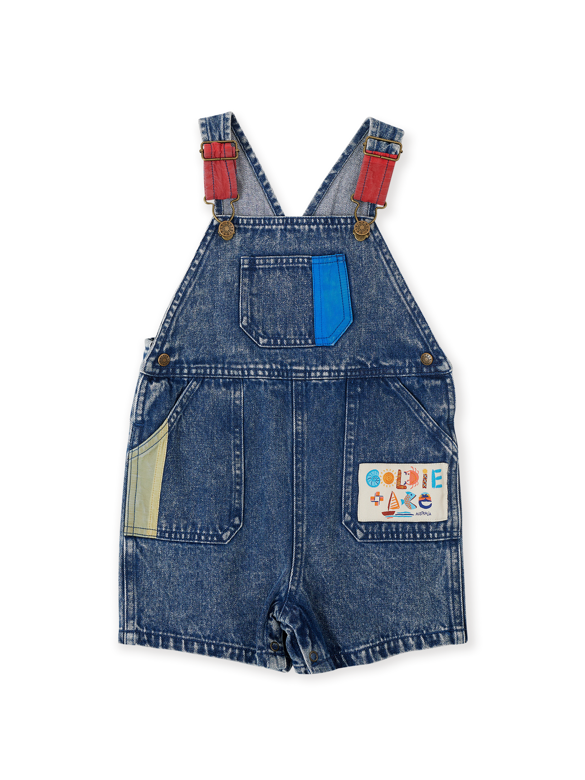 The Goldie + Ace Primary Pop Burton Denim Overalls in Dark Denim pictured on a transparent background. The material is 100% cotton. It is a overall made for babies, toddlers and kids.