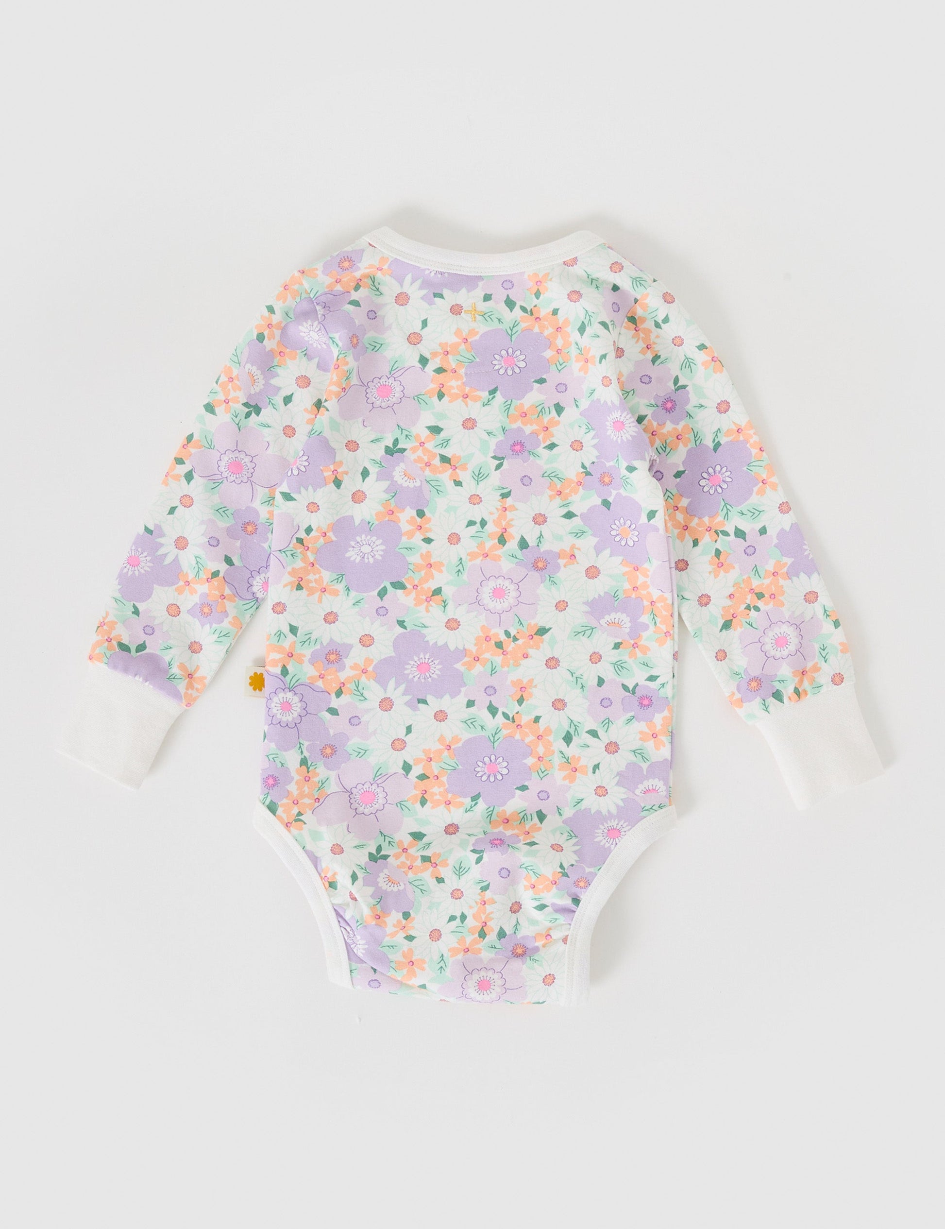The Goldie + Ace Flora Long Sleeve Bodysuit in Lilac Multi pictured on a grey background. The material is soft cotton elastane. It is a babywear made for babies, toddlers and kids.