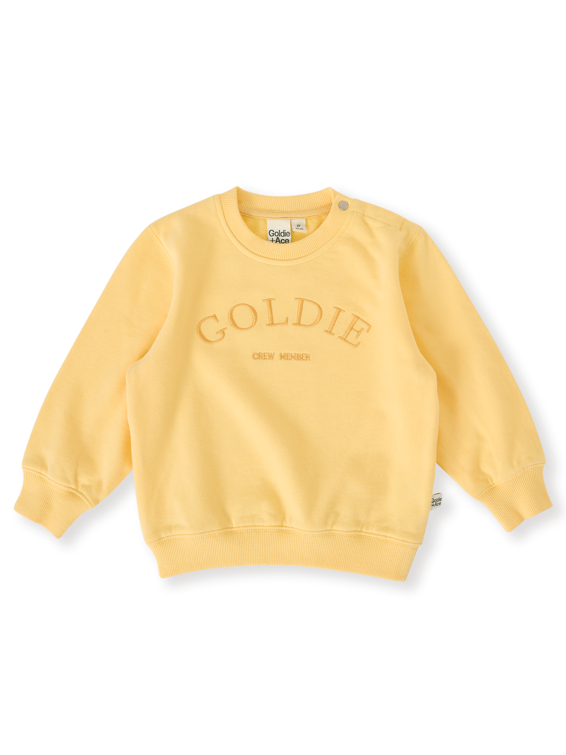 The Goldie + Ace Goldie Crew Embroidered Sweater in Lemon pictured on a transparent background. The material is 100% cotton. It is a top made for babies, toddlers and kids.