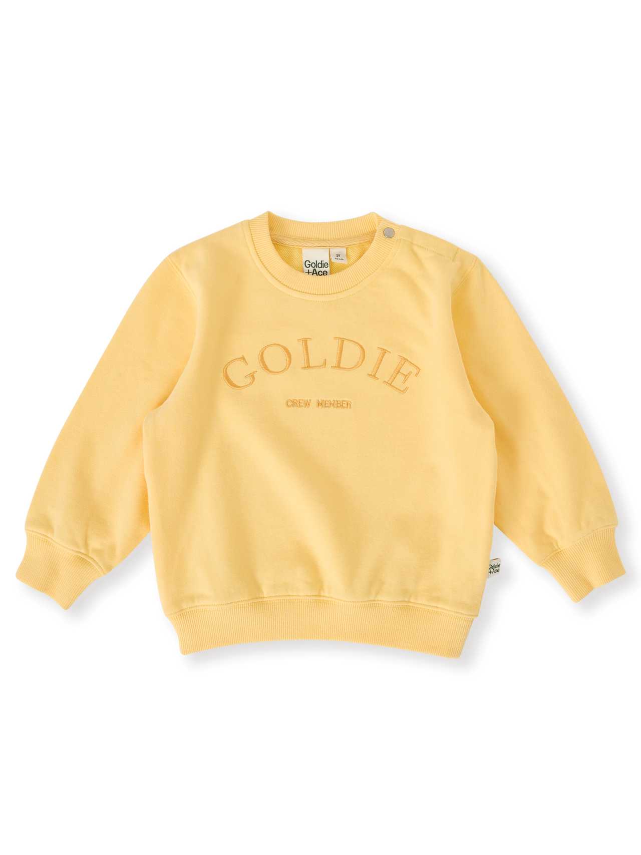 The Goldie + Ace Goldie Crew Embroidered Sweater in Lemon pictured on a transparent background. The material is 100% cotton. It is a top made for babies, toddlers and kids.