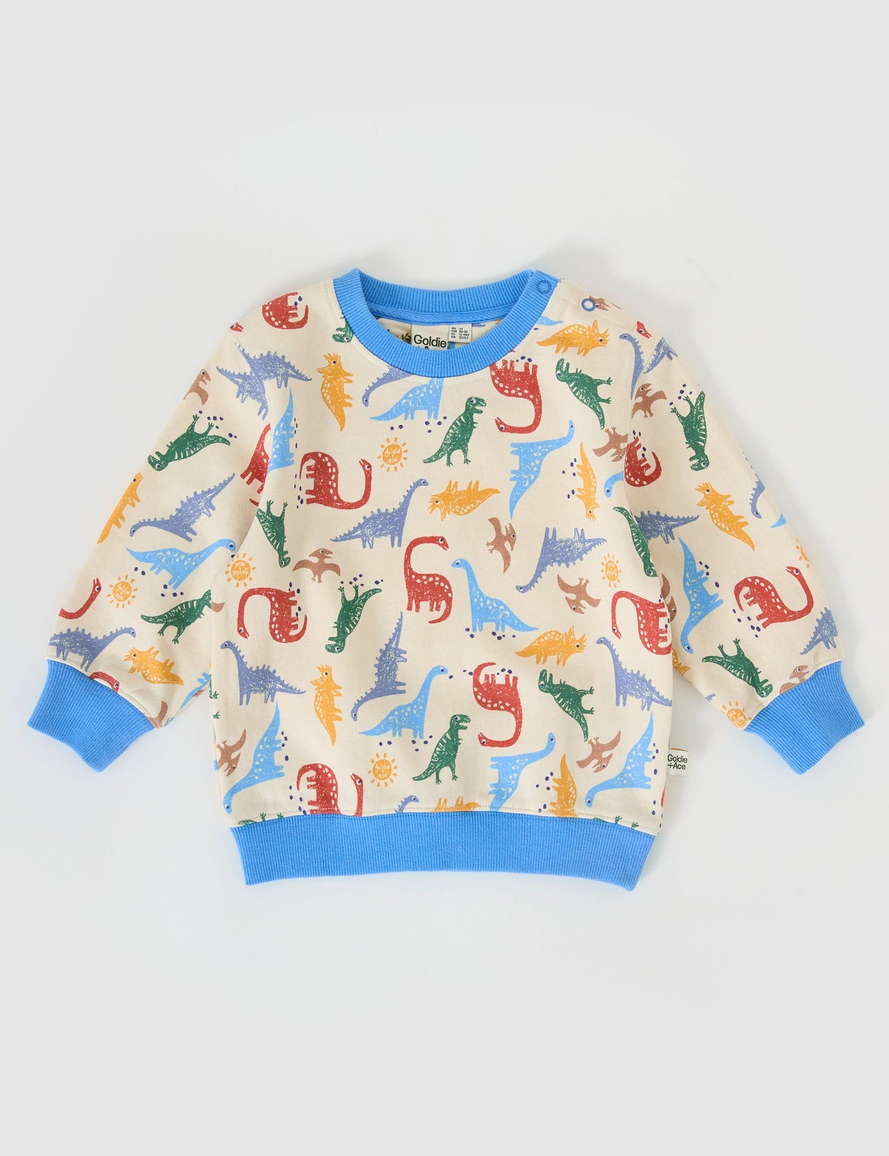 The Goldie + Ace Dino-Mite Relaxed Terry Sweater in Multi pictured on a grey background. The material is cotton terry. It is a top made for babies, toddlers and kids.