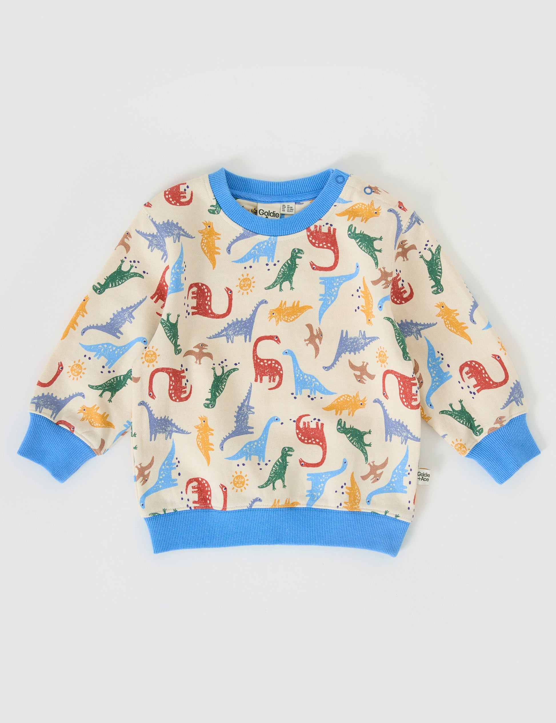 The Goldie + Ace Dino-Mite Relaxed Terry Sweater in Multi pictured on a grey background. The material is cotton terry. It is a top made for babies, toddlers and kids.
