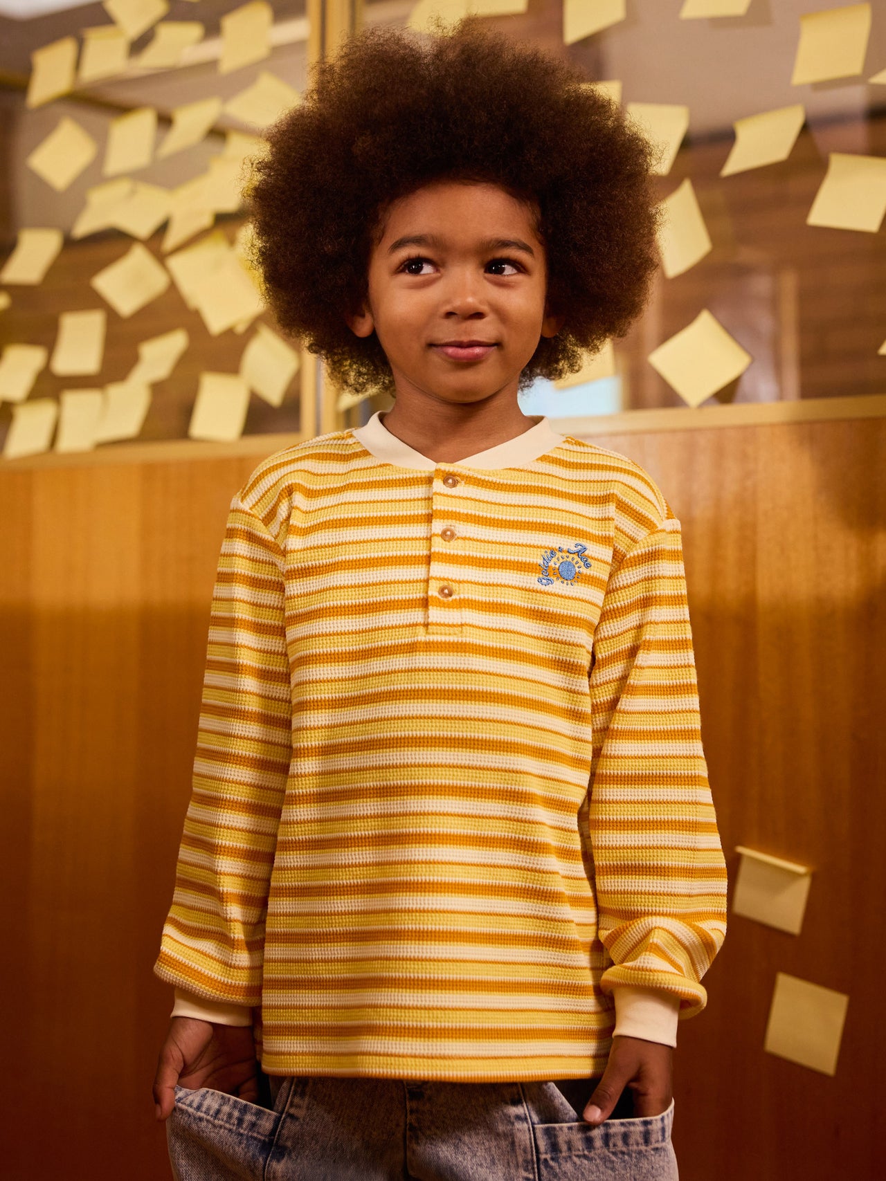 The Goldie + Ace Sunshine Stripe Long Sleeve Top in Lemon/Golden pictured on a transparent background. The material is 100% cotton. It is a top made for babies, toddlers and kids.