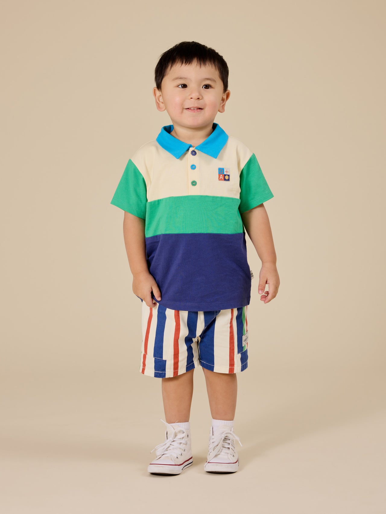 The Goldie + Ace Lewis Colour Block Polo Shirt in Forest/Navy pictured on a transparent background. The material is 100% cotton. It is a top made for babies, toddlers and kids.