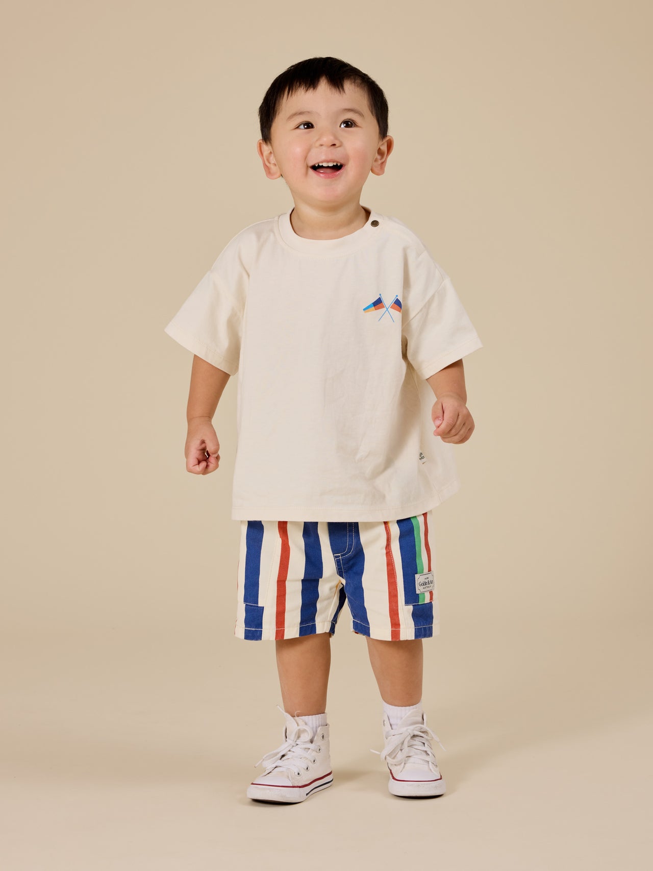 The Goldie + Ace 90's Bold Stripe Noah Denim Pocket Shorts in Primary pictured on a transparent background. The material is 100% cotton. It is a bottom made for babies, toddlers and kids.