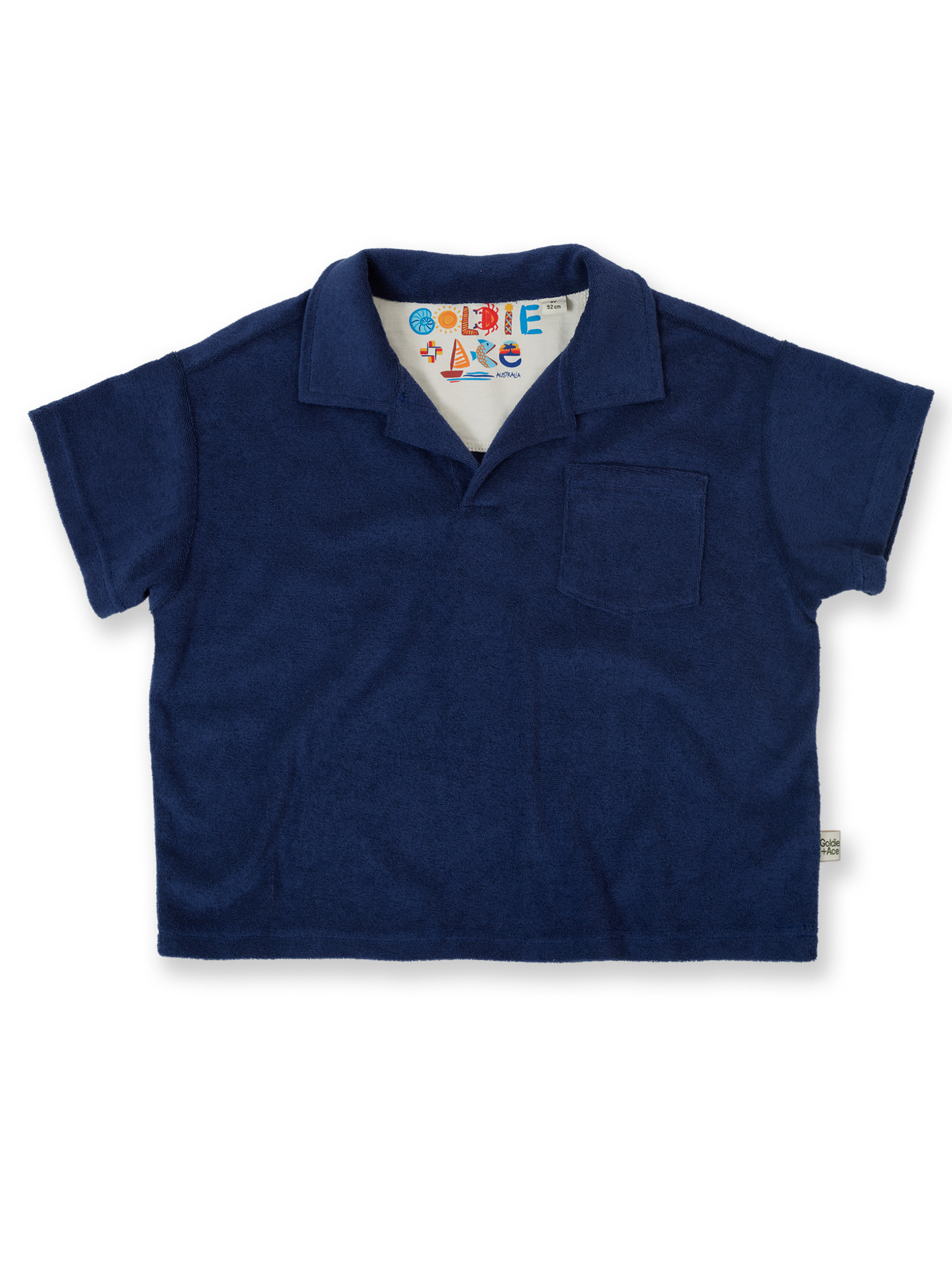 The Goldie + Ace Oversized Terry Polo in Navy pictured on a transparent background. The material is 100% cotton. It is a top made for babies, toddlers and kids.