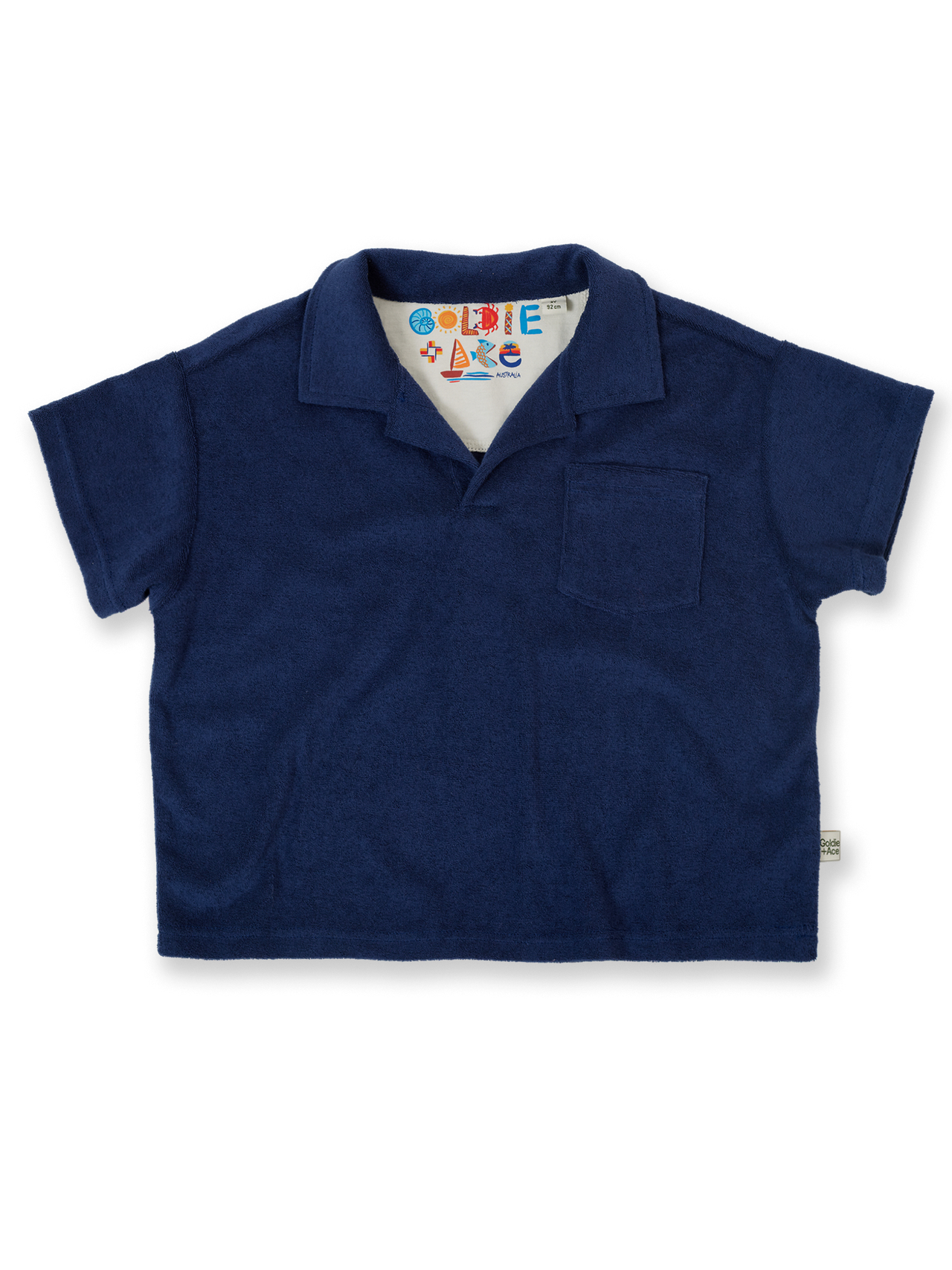 The Goldie + Ace Oversized Terry Polo in Navy pictured on a transparent background. The material is 100% cotton. It is a top made for babies, toddlers and kids.