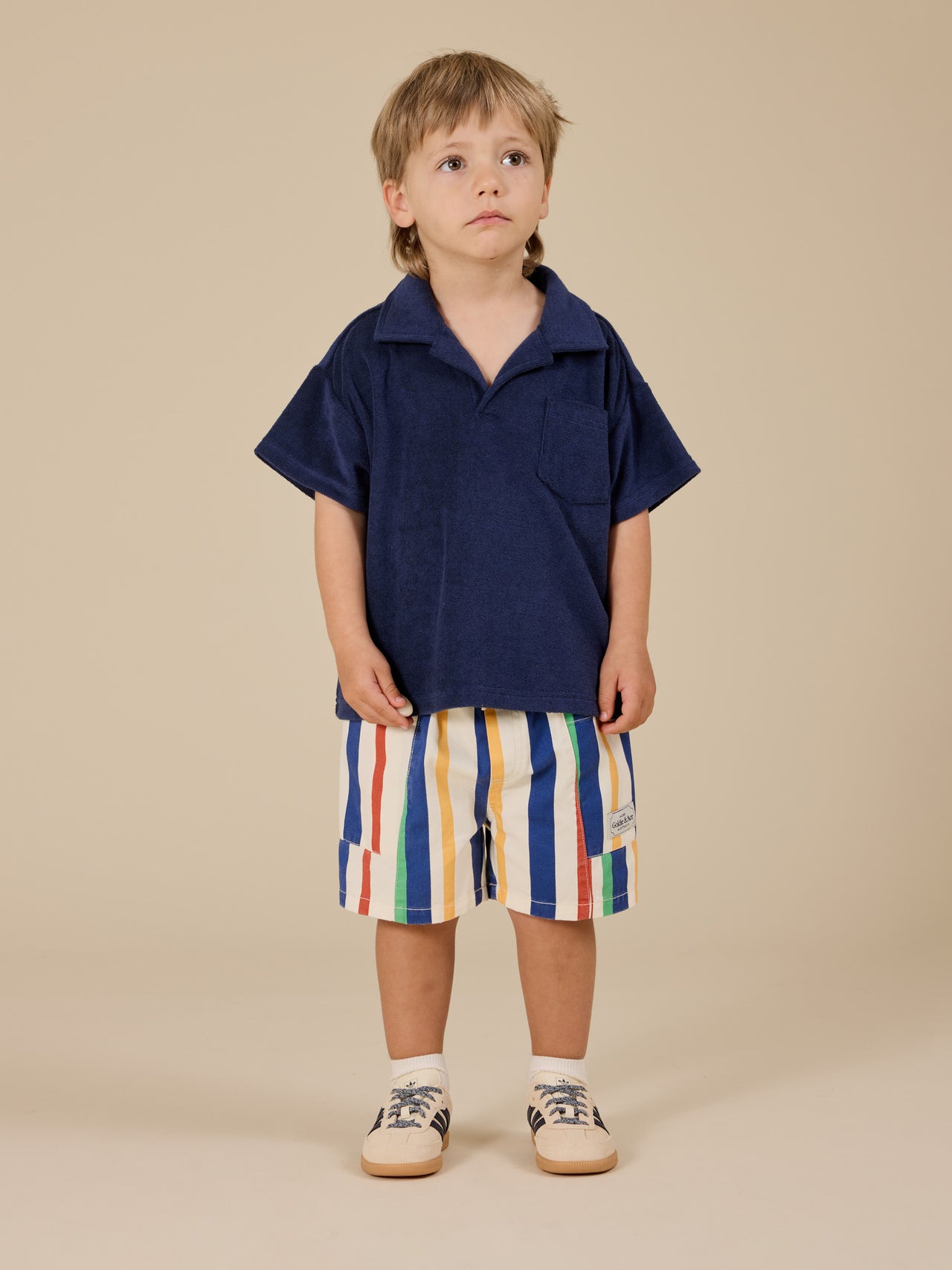 The Goldie + Ace Oversized Terry Polo in Navy pictured on a transparent background. The material is 100% cotton. It is a top made for babies, toddlers and kids.