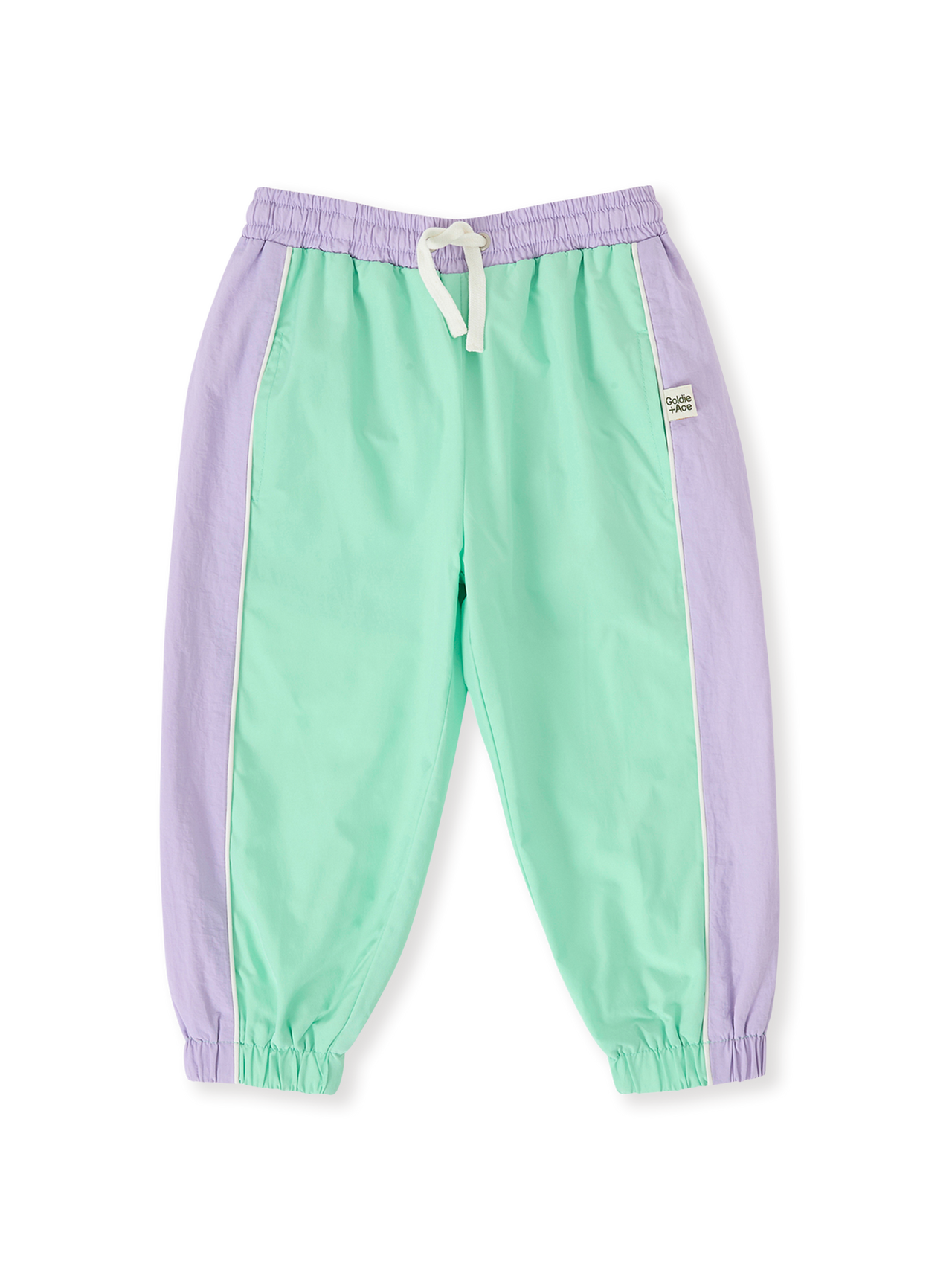 The Goldie + Ace Retro Sporty Pants in Peapod/Lilac pictured on a transparent background. The material is poly with cotton lining. It is a bottom made for babies, toddlers and kids.