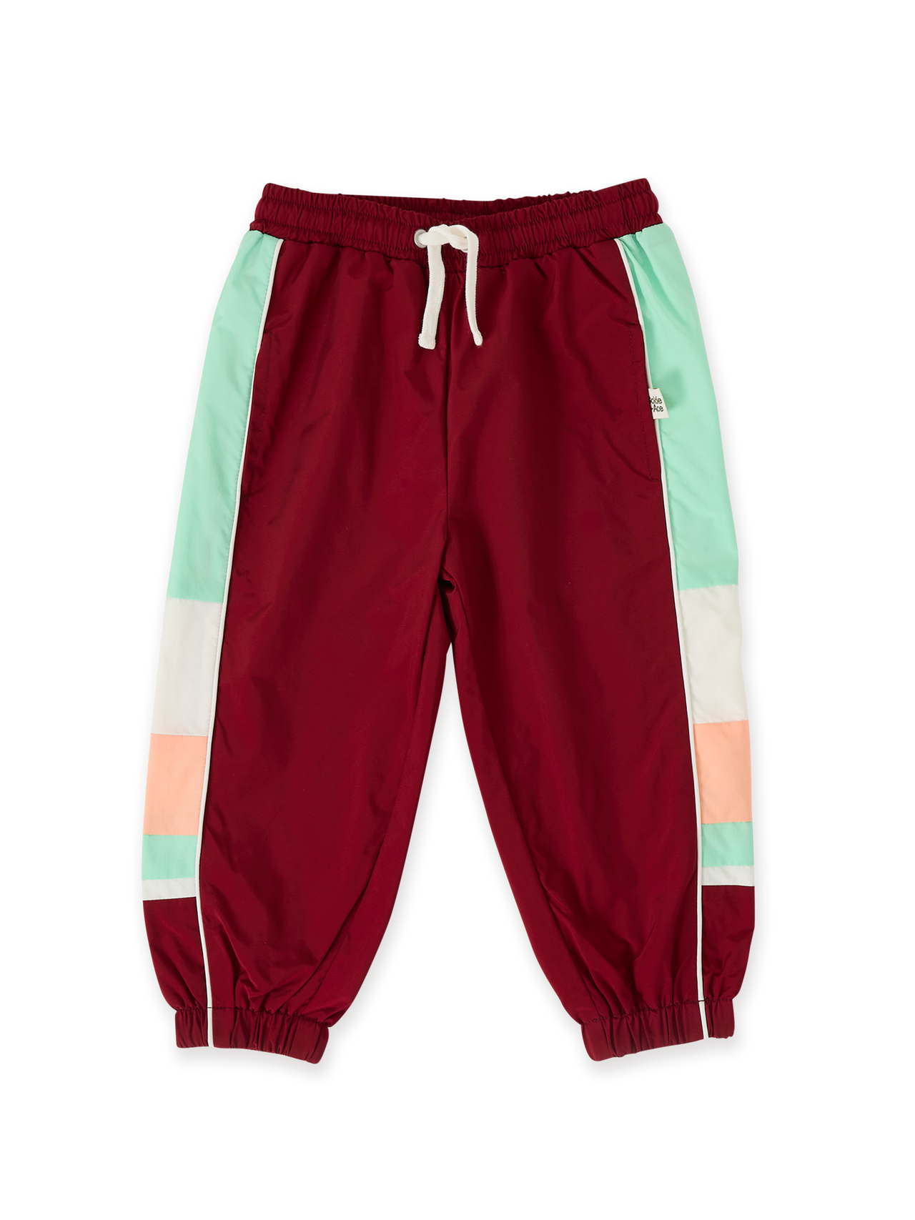 The Goldie + Ace Retro Sporty Pants in Brick/Peapod pictured on a transparent background. The material is poly with cotton lining. It is a bottom made for babies, toddlers and kids.