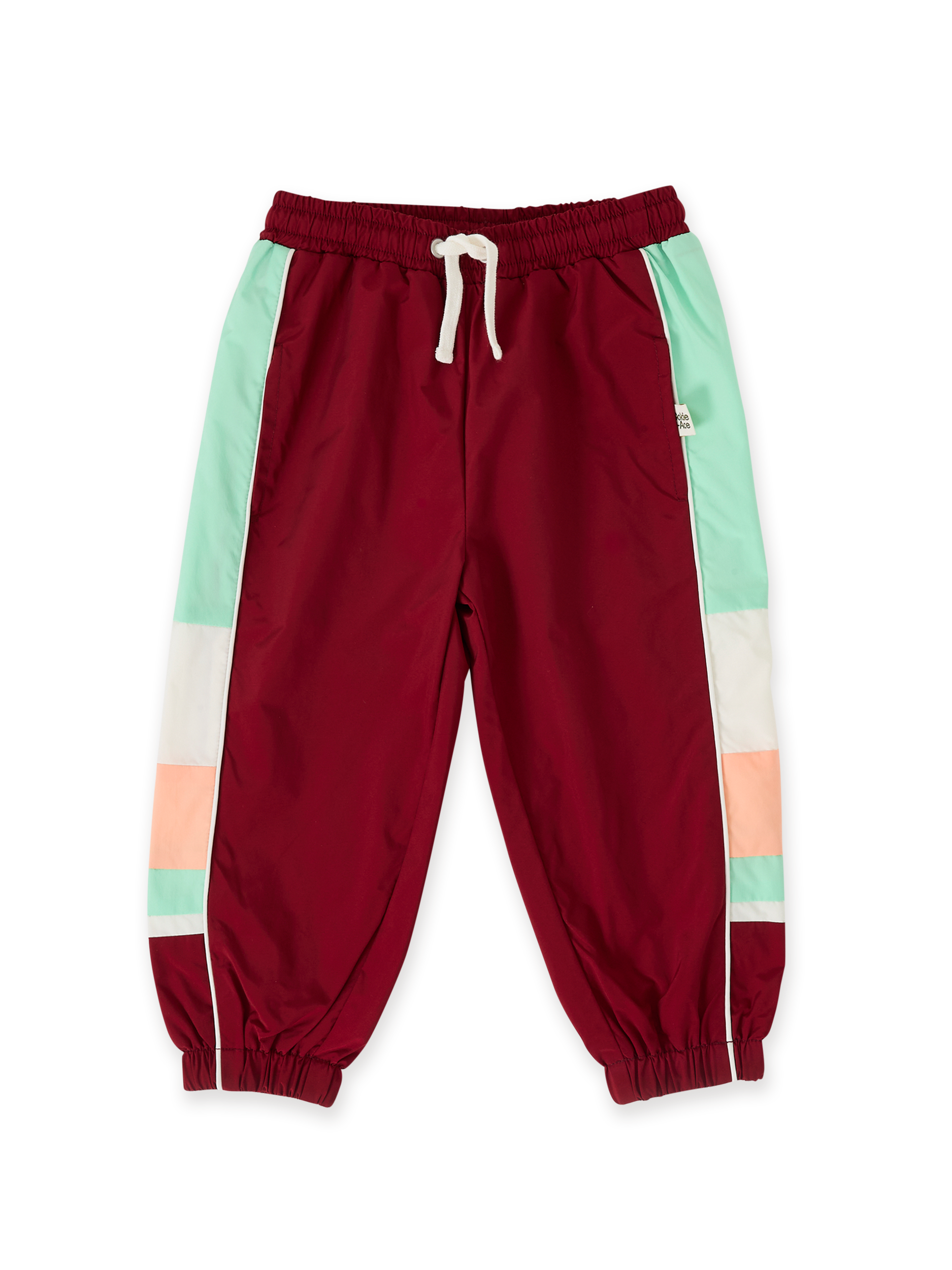 The Goldie + Ace Retro Sporty Pants in Brick/Peapod pictured on a transparent background. The material is poly with cotton lining. It is a bottom made for babies, toddlers and kids.