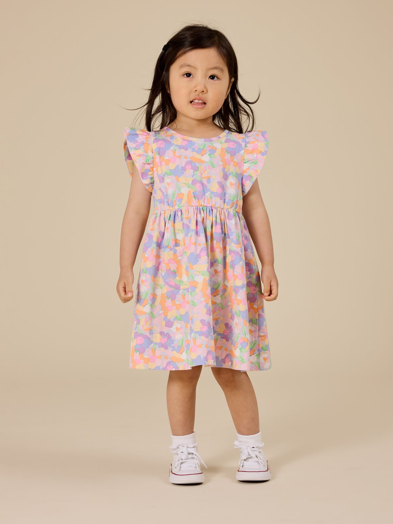 The Goldie + Ace Pastel Bouquet Lyla Dress in Lilac Multi pictured on a transparent background. The material is 100% cotton. It is a dress made for babies, toddlers and kids.
