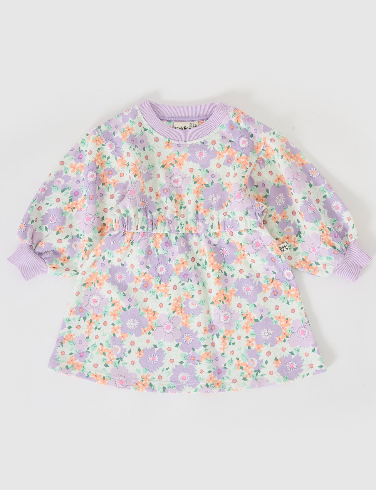 The Goldie + Ace Flora Leah Long Sleeve Dress in Lilac Multi pictured on a grey background. The material is cotton terry. It is a dress made for babies, toddlers and kids.