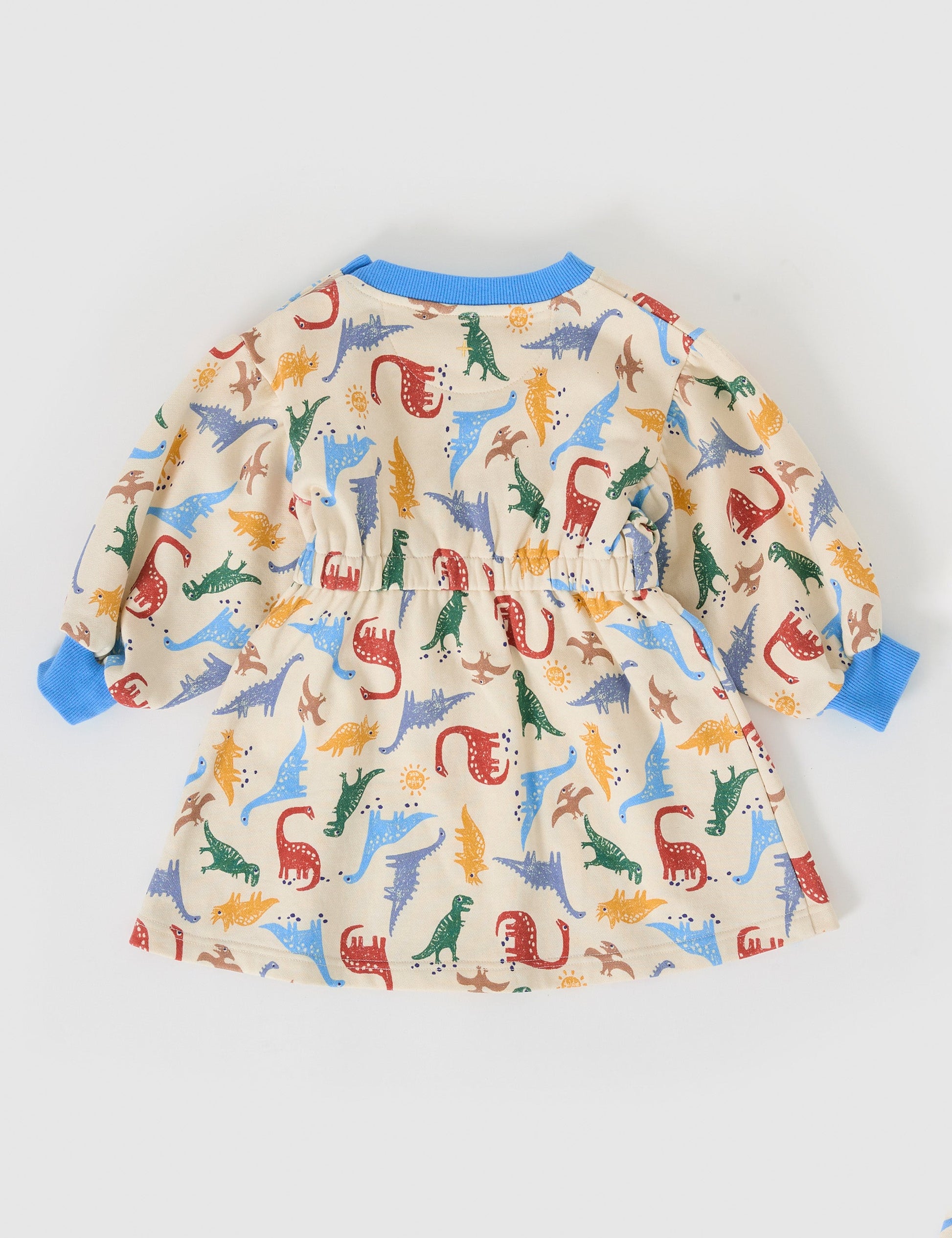 The Goldie + Ace Dino-Mite Leah Long Sleeve Dress in Multi pictured on a grey background. The material is cotton terry. It is a dress made for babies, toddlers and kids.