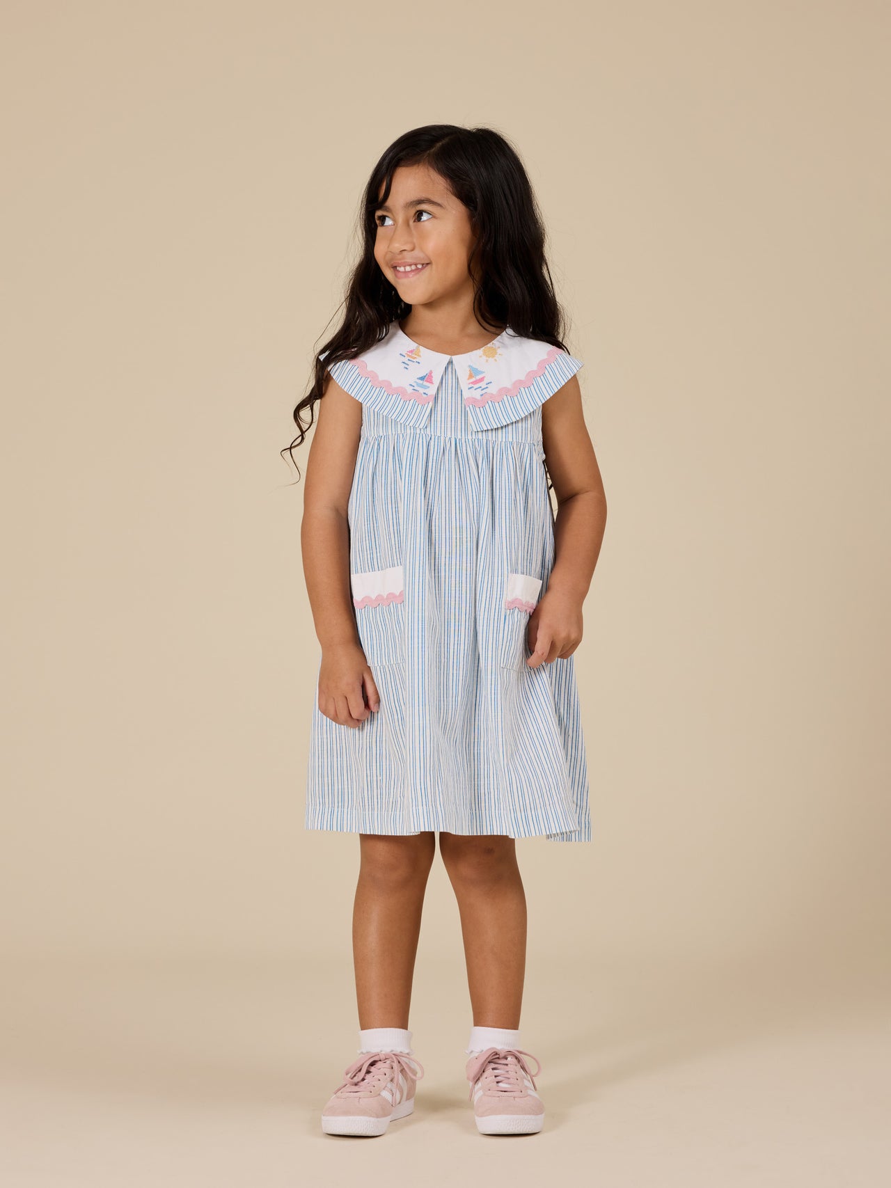 The Goldie + Ace Sailor Stripe Lucy Collared Dress in Ocean/Ivory pictured on a transparent background. The material is soft and breathable rayon-linen blend. It is a dress made for babies, toddlers and kids.