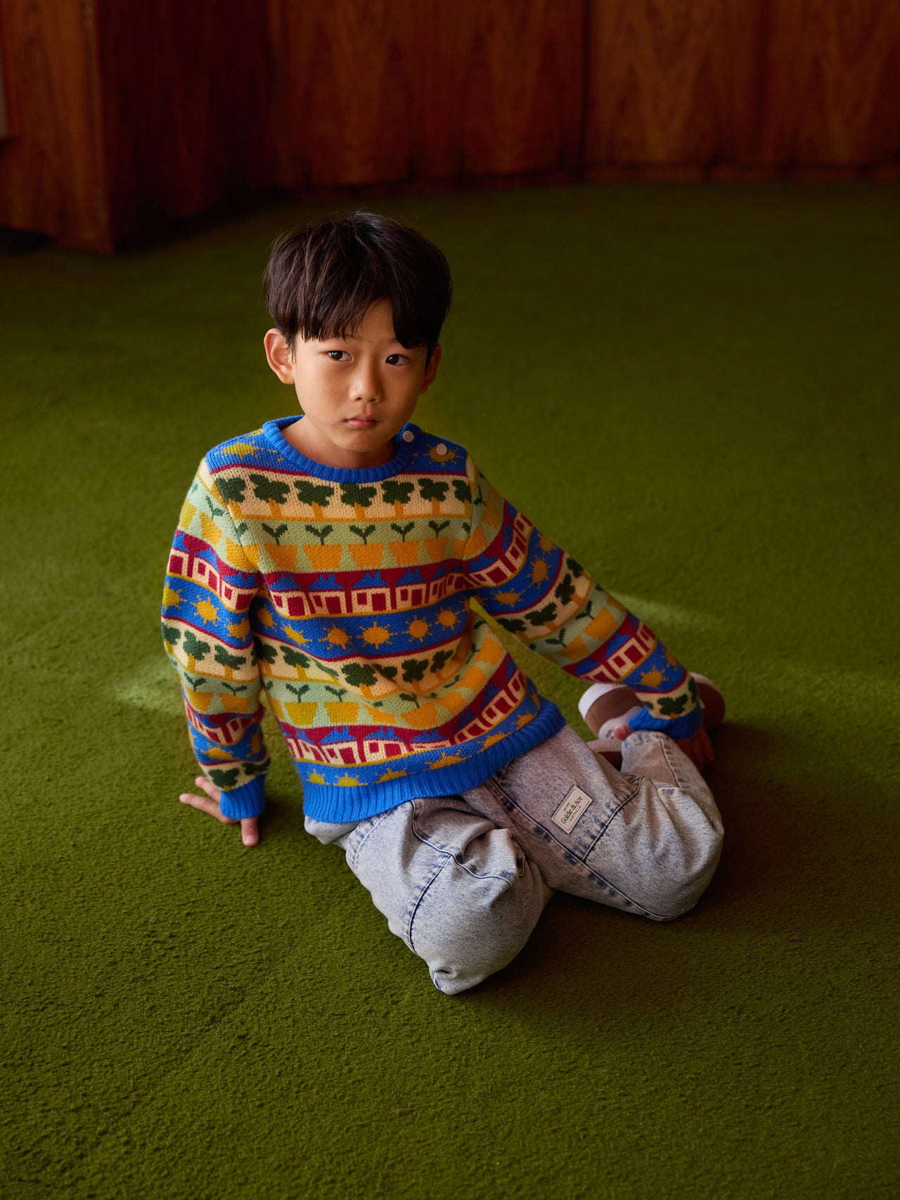 The Goldie + Ace Among The Gumtrees Knit Jumper in Blue Multi pictured on a transparent background. The material is soft knit made from wool, acrylic, and nylon. It is a knit made for babies, toddlers and kids.