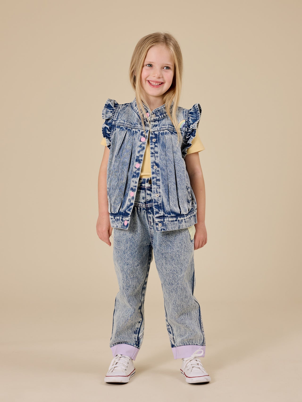 The Goldie + Ace Elodie Embroidered Denim Vest in Light Denim pictured on a transparent background. The material is cotton. It is a top made for babies, toddlers and kids.
