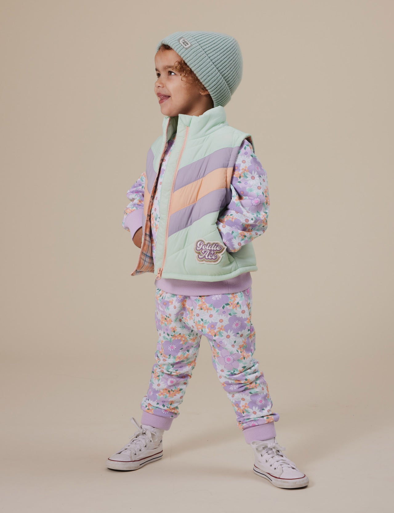 The Goldie + Ace Panelled Vest in Mint pictured on a grey background. The material is poly with poly filling. It is a top made for babies, toddlers and kids.