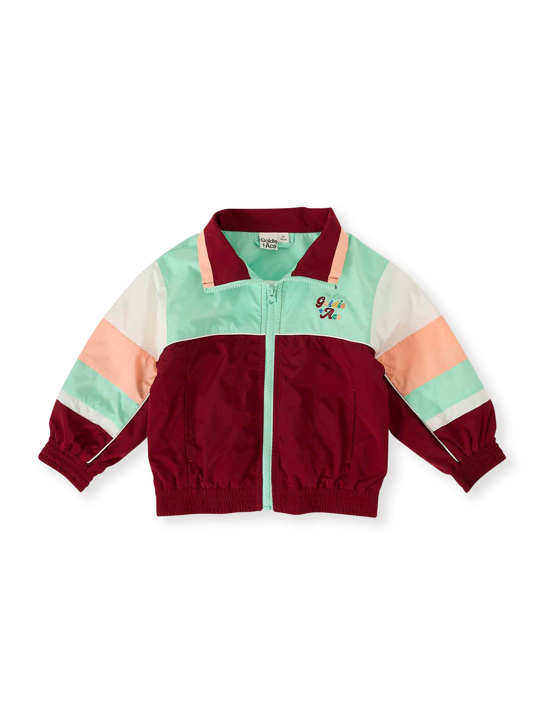The Goldie + Ace Fun Run Retro Spray Jacket in Brick/Peapod pictured on a transparent background. The material is poly with cotton lining. It is a jacket made for babies, toddlers and kids.