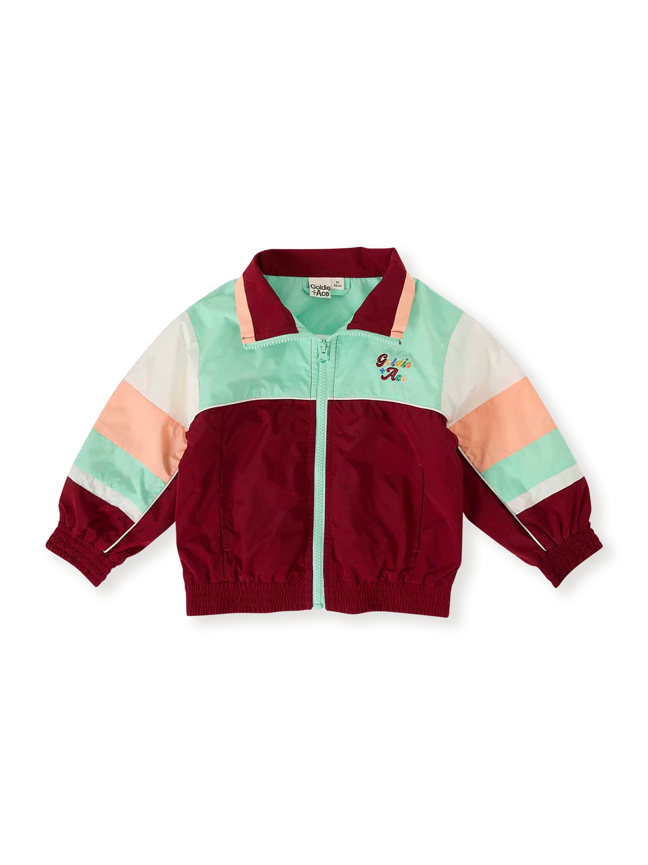 The Goldie + Ace Fun Run Retro Spray Jacket in Brick/Peapod pictured on a transparent background. The material is poly with cotton lining. It is a jacket made for babies, toddlers and kids.