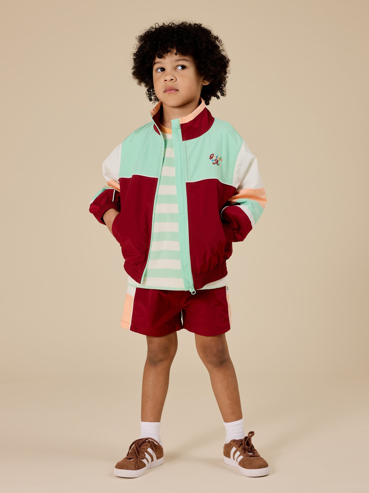 The Goldie + Ace Retro Sporty Shorts in Brick/Peapod pictured on a transparent background. The material is poly with cotton lining. It is a bottom made for babies, toddlers and kids.