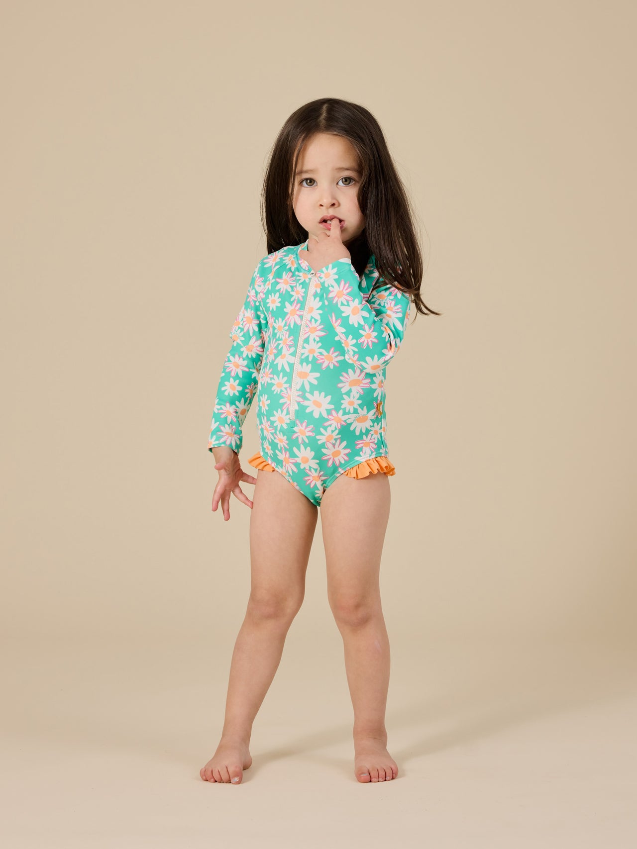 The Goldie + Ace Daisy Patch Long Sleeve Frill Swimsuit in Moss pictured on a transparent background. The material is . It is a swimwear made for babies, toddlers and kids.