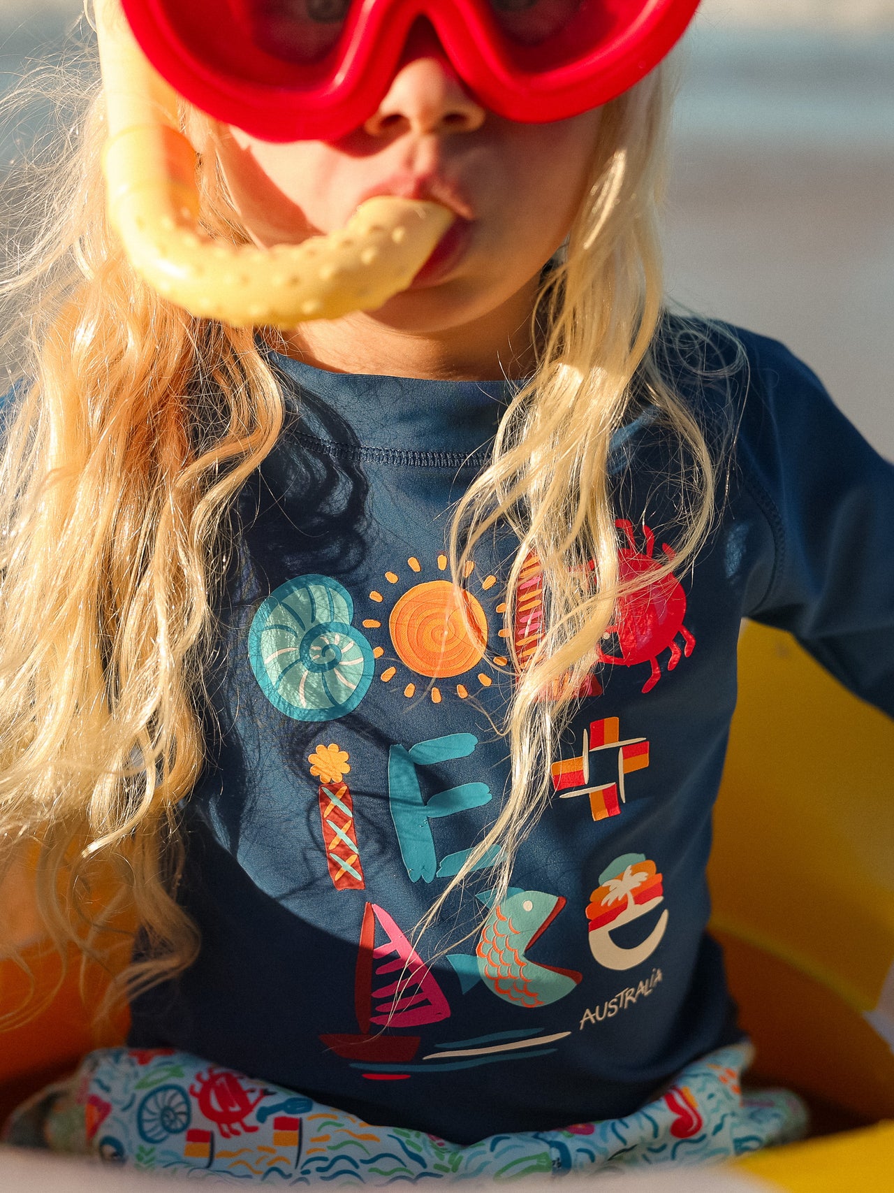 The Goldie + Ace G'Day From The Bay Rashguard in Navy pictured on a transparent background. The material is . It is a swimwear made for babies, toddlers and kids.
