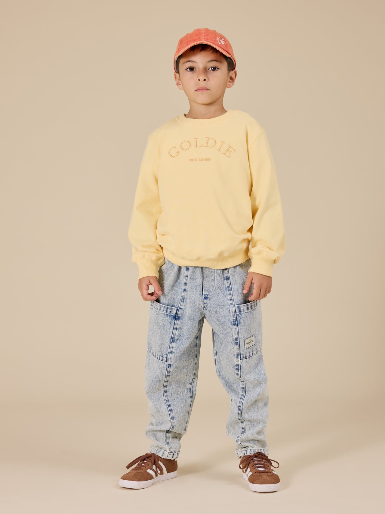 The Goldie + Ace Goldie Crew Embroidered Sweater in Lemon pictured on a transparent background. The material is 100% cotton. It is a top made for babies, toddlers and kids.