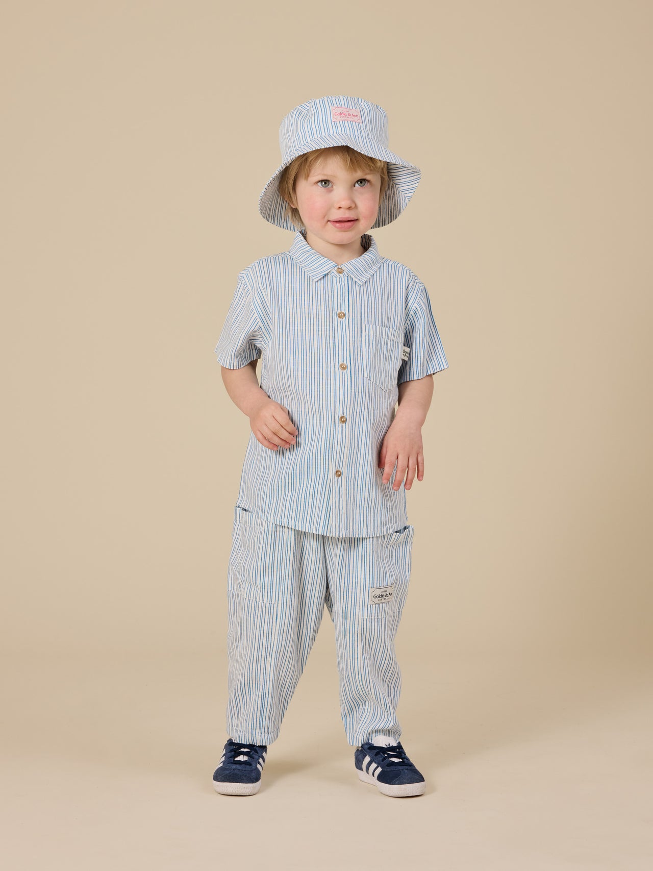 The Goldie + Ace Sailor Stripe Kit Linen Pants in Ocean/Ivory pictured on a transparent background. The material is soft and breathable rayon-linen blend. It is a bottom made for babies, toddlers and kids.