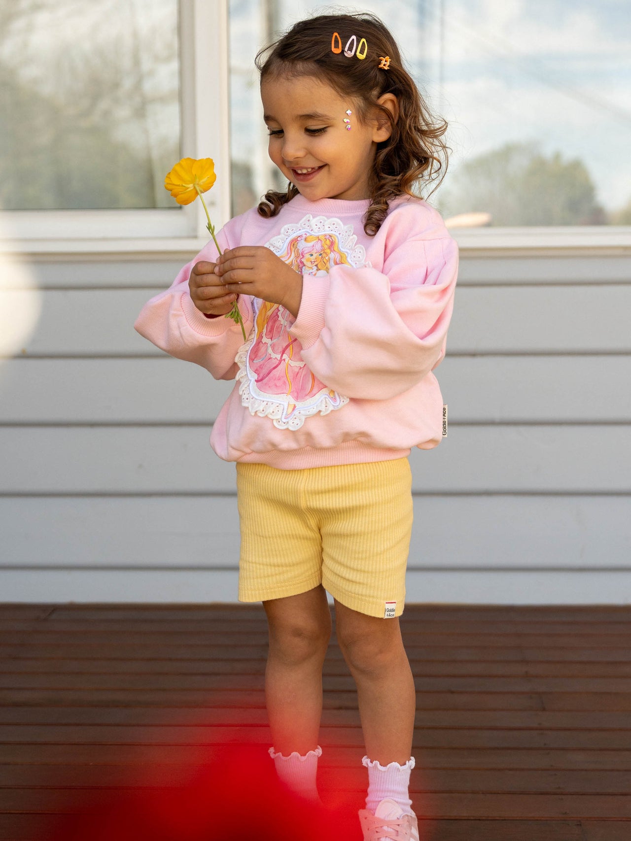 The Goldie + Ace Lara Rib Shorties in Lemon pictured on a transparent background. The material is soft cotton elastane. It is a bottom made for babies, toddlers and kids.