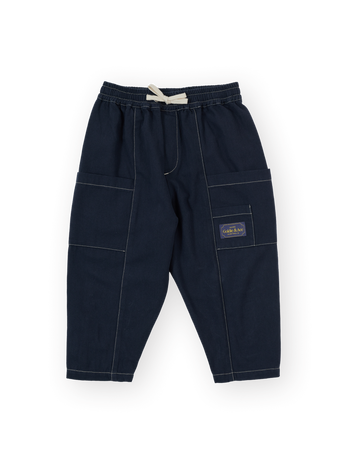 The Goldie + Ace Carpenter Utility Kit Pocket Pant in Navy pictured on a transparent background. The material is 100% cotton. It is a pant made for babies, toddlers and kids.