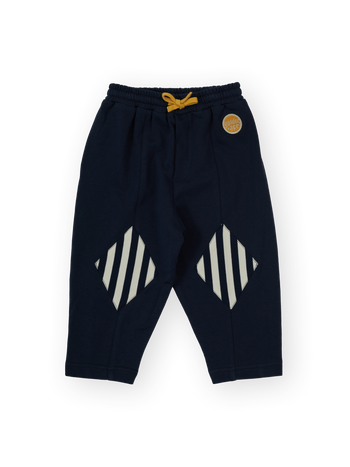 The Goldie + Ace Diamond Patch Sweat Pant in Navy pictured on a transparent background. The material is 100% cotton. It is a sweatpant made for babies, toddlers and kids.