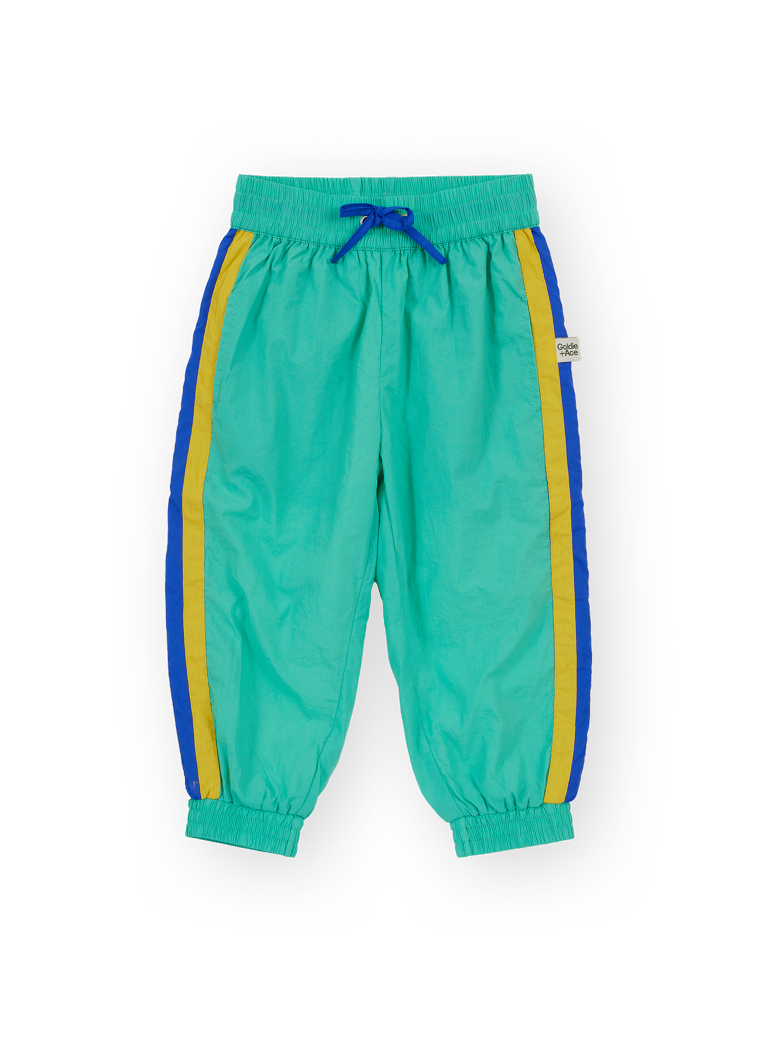 The Goldie + Ace Retro Lightweight Sporty Pants in Blue & Green pictured on a transparent background. The material is 100% polyester, filling: 100% cotton. It is a pant made for babies, toddlers and kids.