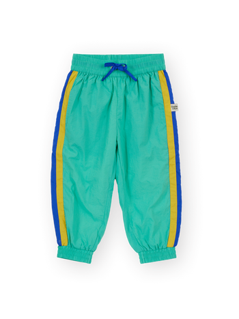 The Goldie + Ace Retro Lightweight Sporty Pants in Blue & Green pictured on a transparent background. The material is 100% polyester, filling: 100% cotton. It is a pant made for babies, toddlers and kids.