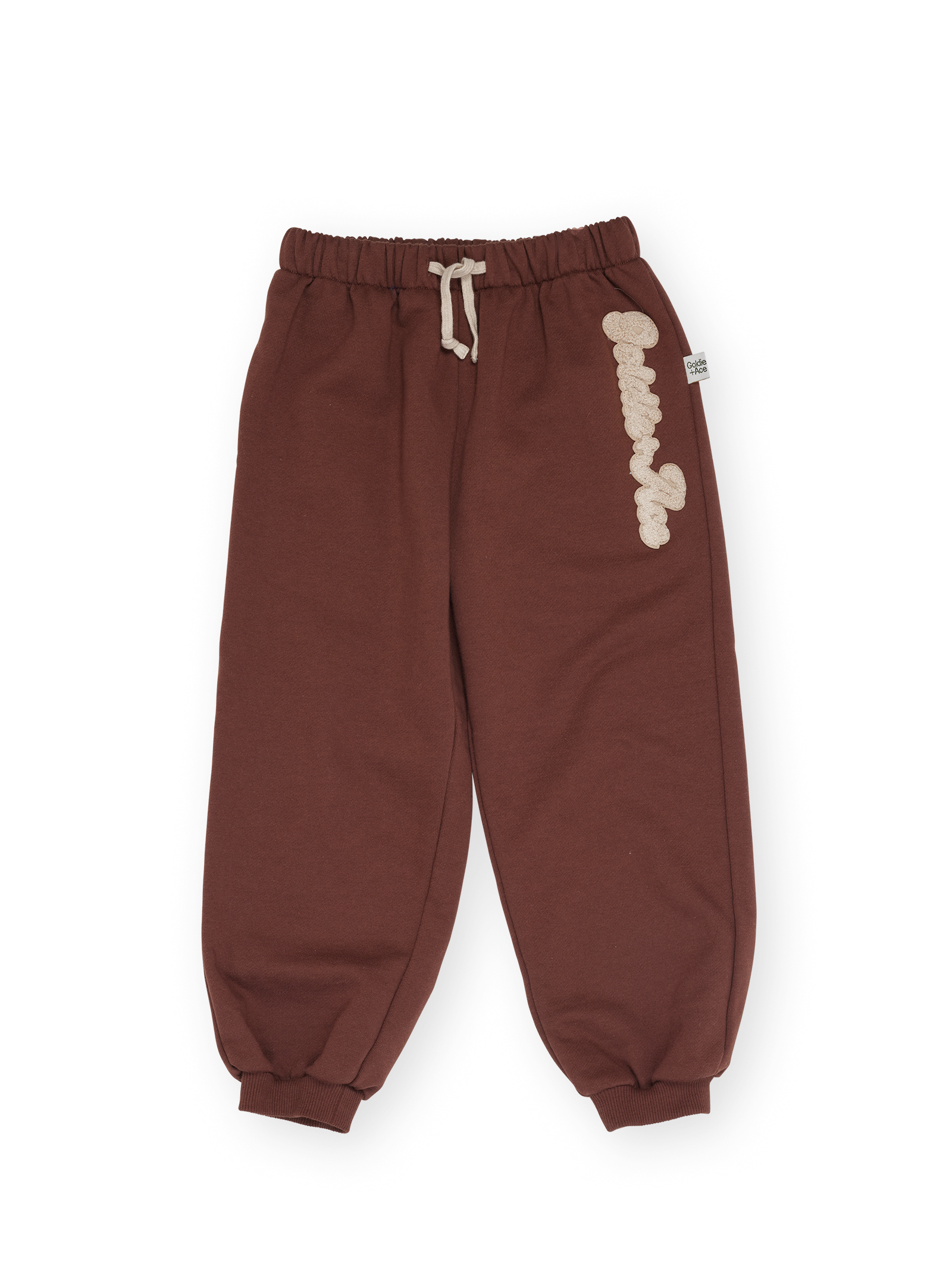 The Goldie + Ace Comfy Embroidered Sweatpants in Chestnut pictured on a transparent background. The material is 100% cotton. It is a sweatpant made for babies, toddlers and kids.