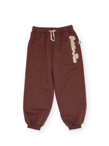 The Goldie + Ace Comfy Embroidered Sweatpants in Chestnut pictured on a transparent background. The material is 100% cotton. It is a sweatpant made for babies, toddlers and kids.