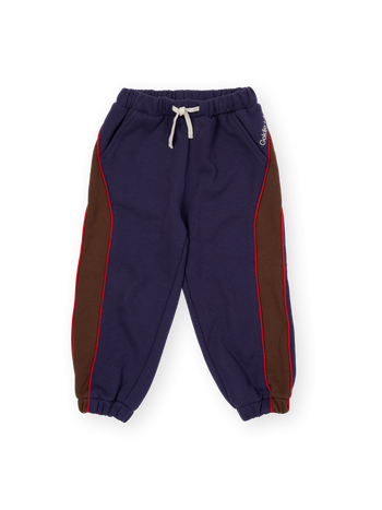 The Goldie + Ace Zig Zag Sweat Pant in Navy & Brown pictured on a transparent background. The material is 100% cotton. It is a sweatpant made for babies, toddlers and kids.