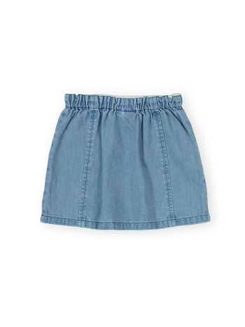 The Goldie + Ace Wild Strawberry Chambray Skirt in Vintage Blue pictured on a transparent background. The material is 100% cotton. It is a skirt made for babies, toddlers and kids.