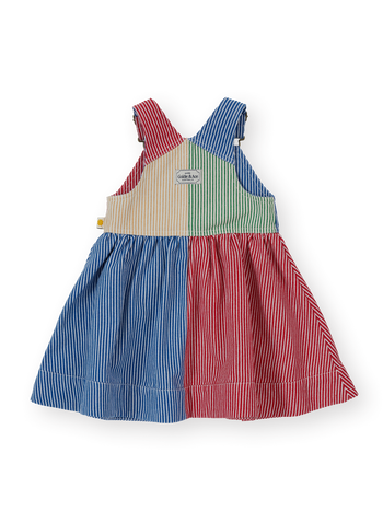 The Goldie + Ace Patchwork Stripe Heidi Pinafore Dress in Primary pictured on a transparent background. The material is 55% polyester 45% cotton. It is a dress made for babies, toddlers and kids.