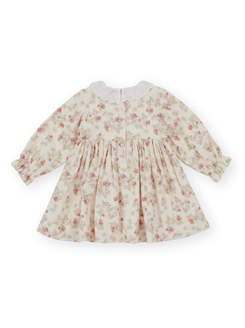 The Goldie + Ace Strawberry Fields Smocked Dress in Cream pictured on a transparent background. The material is 100% cotton. It is a dress made for babies, toddlers and kids.