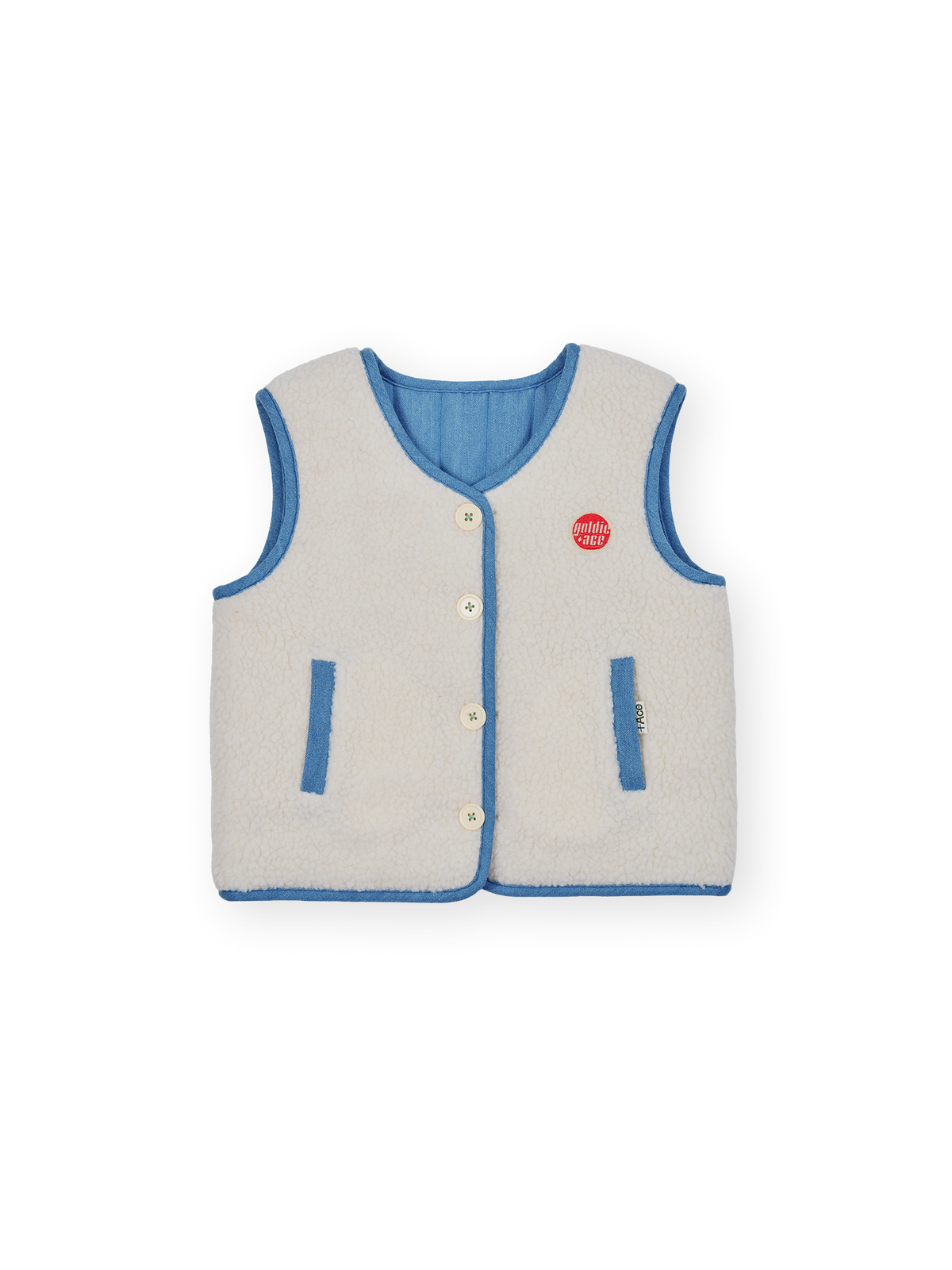 The Goldie + Ace Reversible Chambray Button Vest in Natural &amp; Vintage Blue pictured on a transparent background. The material is 100% cotton, 100% polyester reverse side. It is a vest made for babies, toddlers and kids.