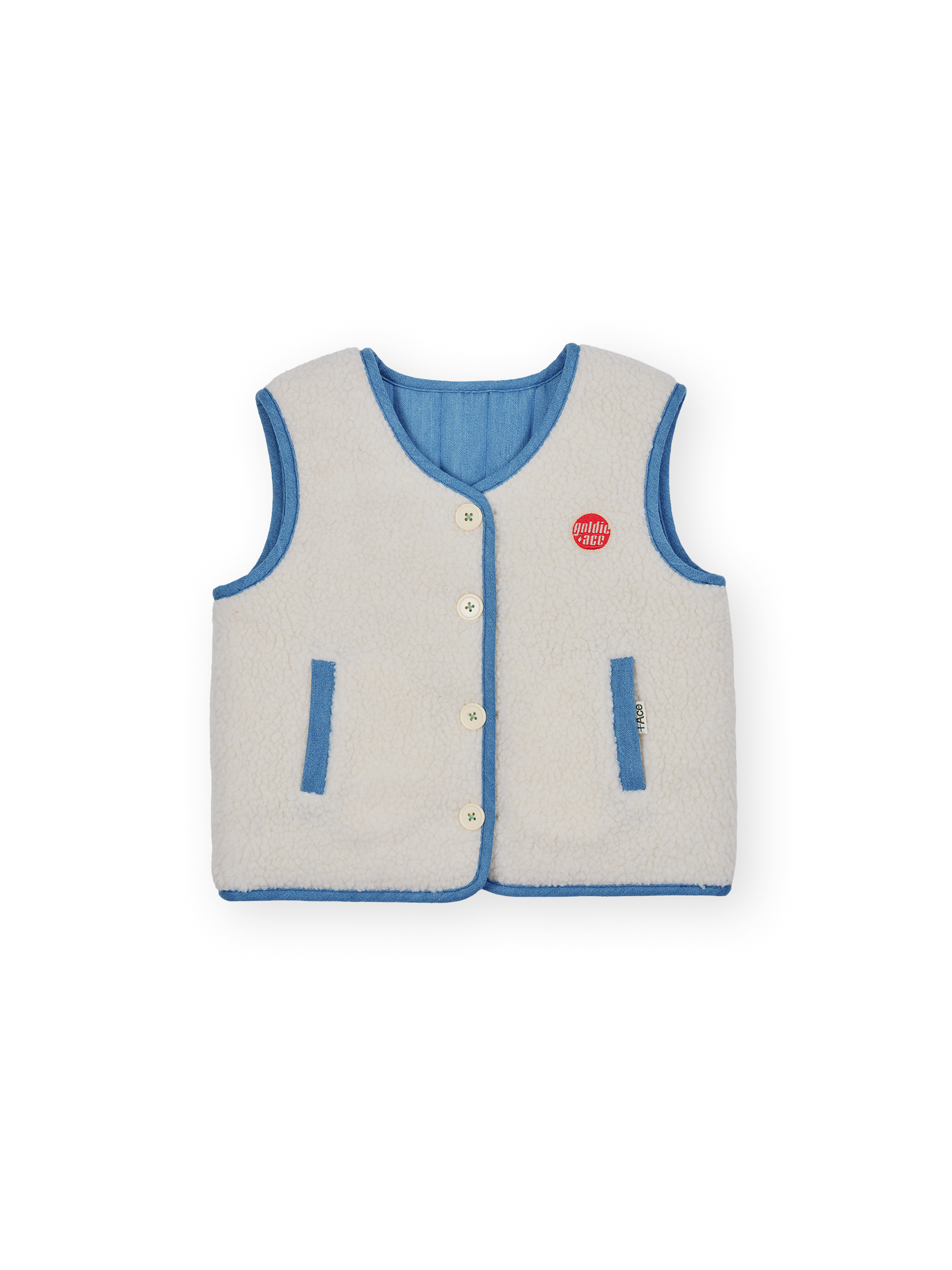 The Goldie + Ace Reversible Chambray Button Vest in Natural & Vintage Blue pictured on a transparent background. The material is 100% cotton, 100% polyester reverse side. It is a vest made for babies, toddlers and kids.
