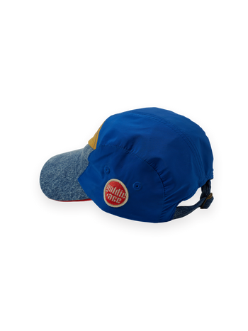 The Goldie + Ace Colour Block Vintage Denim Cap in Dark Denim & Multi pictured on a transparent background. The material is 100% cotton, 100% polyester coloured panels, 100% cotton lining. It is a hat made for babies, toddlers and kids.