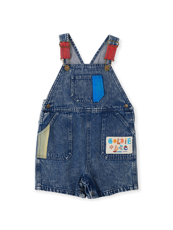 The Goldie + Ace Primary Pop Burton Denim Overalls in Dark Denim pictured on a transparent background. The material is 100% cotton. It is a overall made for babies, toddlers and kids.