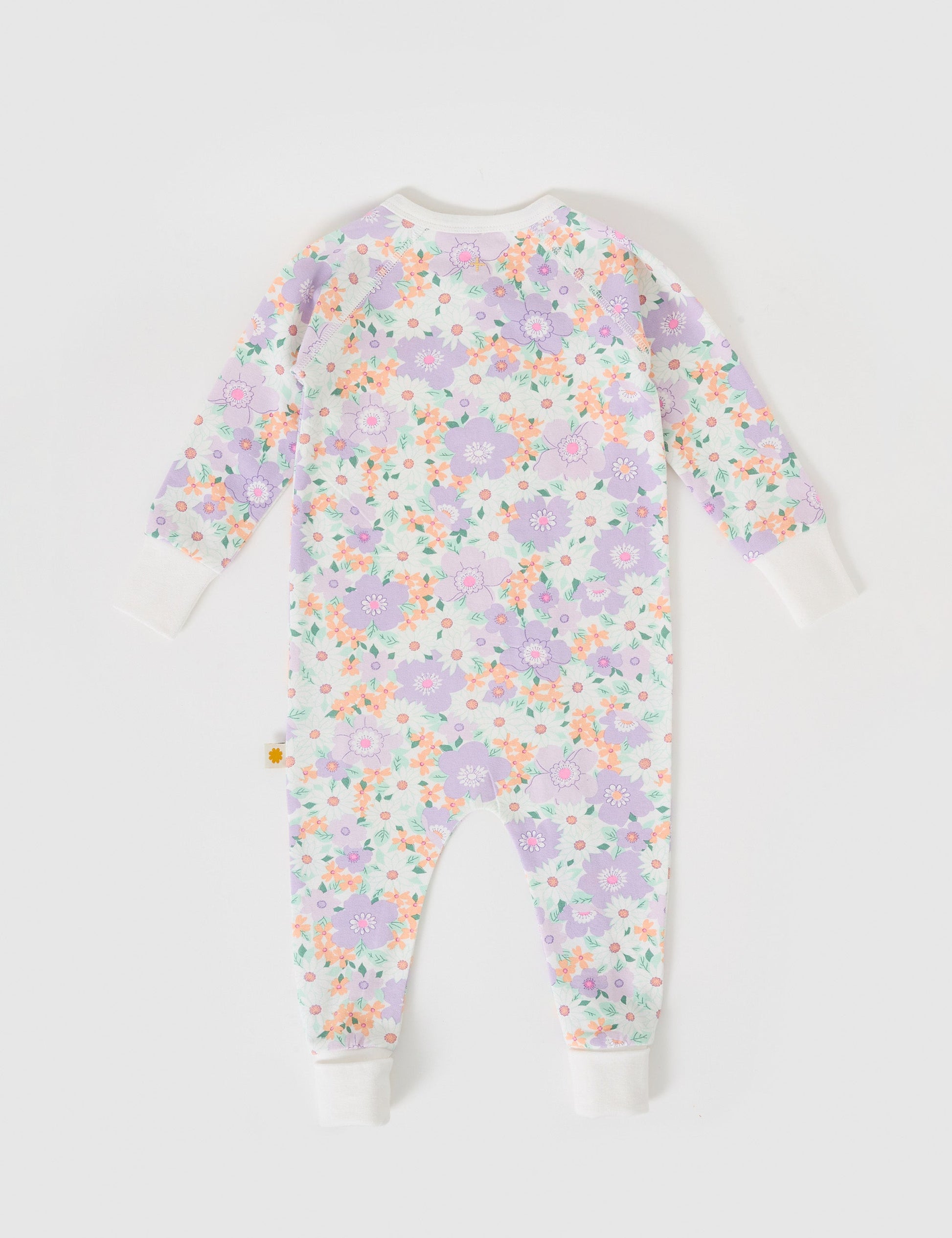 The Goldie + Ace Flora Zipsuit in Lilac Multi pictured on a grey background. The material is soft cotton elastane. It is a babywear made for babies, toddlers and kids.