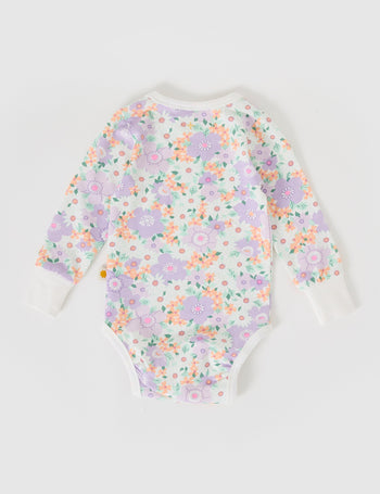 The Goldie + Ace Flora Long Sleeve Bodysuit in Lilac Multi pictured on a grey background. The material is soft cotton elastane. It is a babywear made for babies, toddlers and kids.