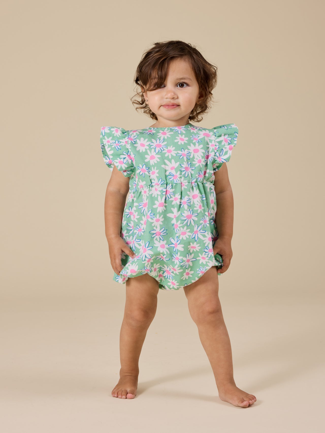 The Goldie + Ace Daisy Patch Lani Romper in Moss pictured on a transparent background. The material is breathable cotton-linen blend. It is a romper made for babies, toddlers and kids.