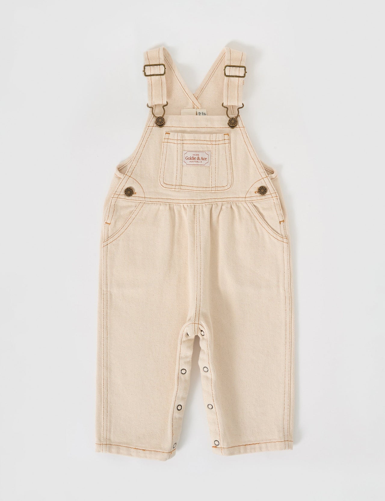 The Goldie + Ace Austin Denim Overalls in Oat pictured on a grey background. The material is cotton denim. It is a overall made for babies, toddlers and kids.